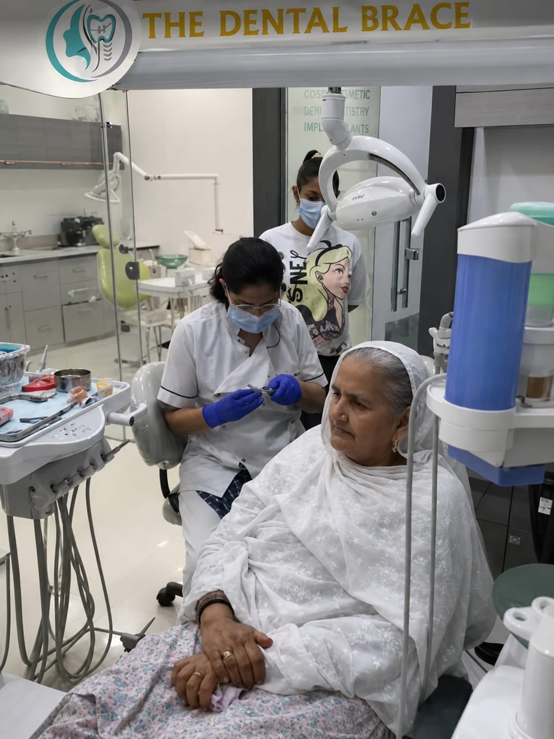 Dr. Ritu Saneja treating a patient with the dental team at The DentalBrace Clinic Bathinda — providing expert dental implant and prosthodontics treatment