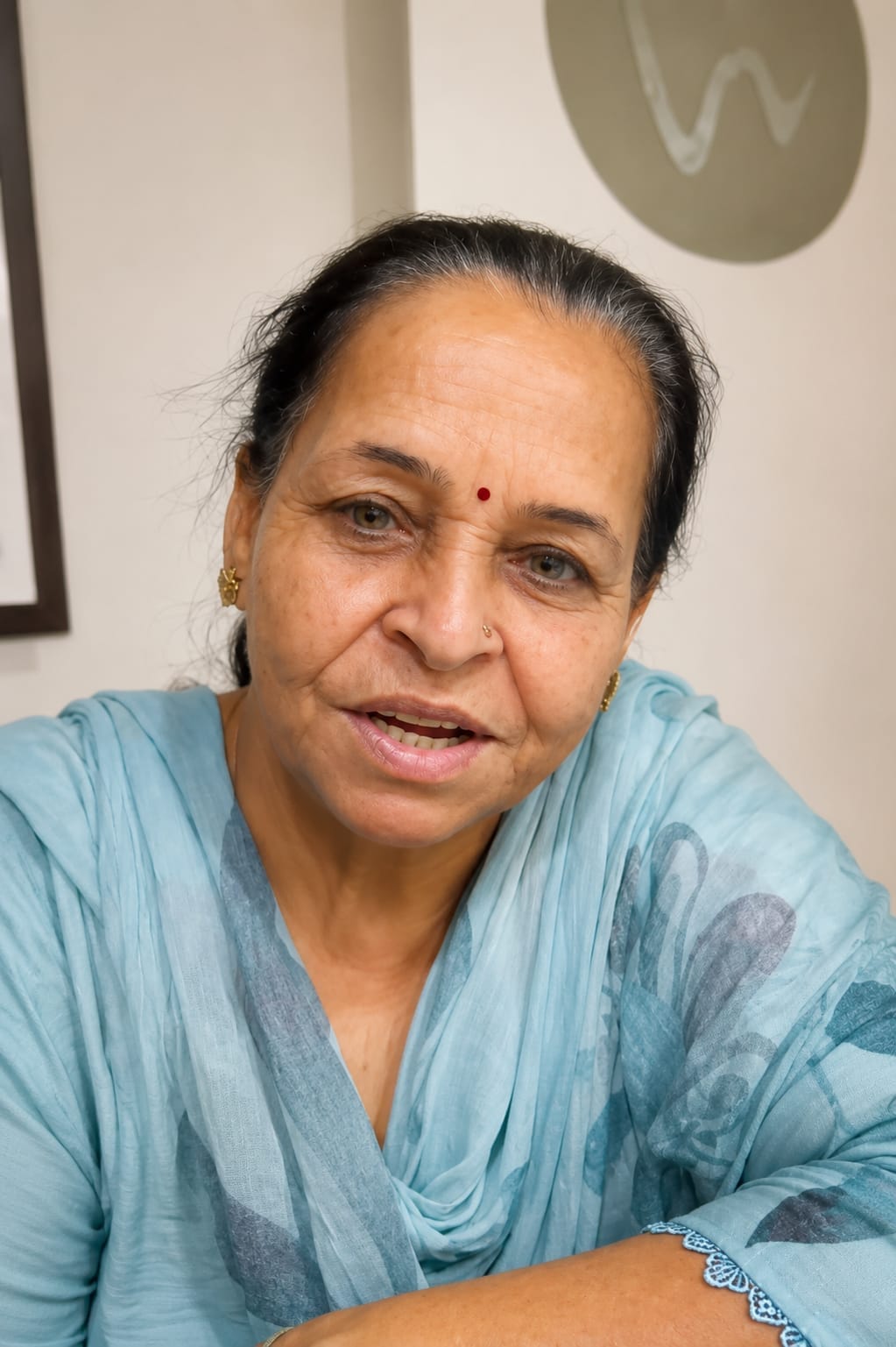 Dental implants and complete dentures treatment result at The DentalBrace Clinic Bathinda — patient Usha Rani showing fixed dentures by Dr. Ritu Saneja Gold Medalist Prosthodontist, best dental implants clinic in Bathinda Punjab India